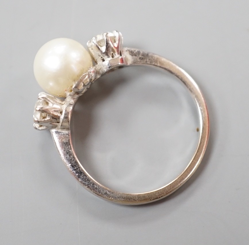 A white metal (stamped plat), single stone diamond and two stone cultured pearl set dress ring, size M, gross weight 4.2 grams.